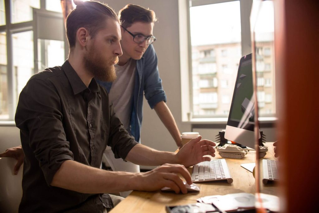 two-young-men-working-with-computer